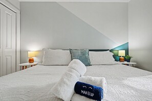 A neatly made bed with white bedding and a folded towel with 'MAKEUP' on it. - Newly renovated house in Lake Harmony w/ Hot Tub, Gameroom & Summer Beach Access (Lake Harmony)