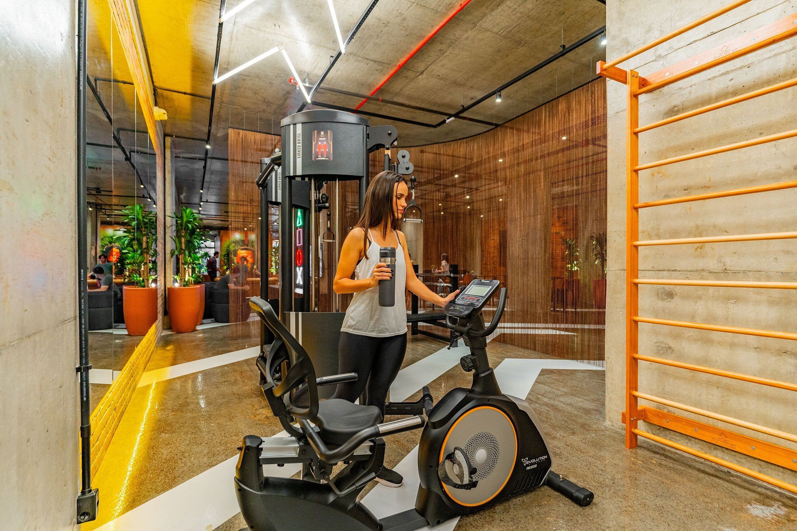 A gym with exercise equipment, including a stationary bike and a weight machine.
