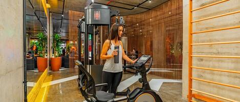 A gym with exercise equipment, including a stationary bike and a weight machine.