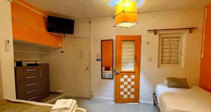 Private apartment up to 5. A/C, TV, Wi-Fi, fridge, kitchen and living room. Steps from the beach.