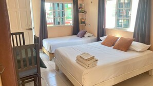 A hotel room with two beds, a wooden chair, a desk, and a window with curtains. - Studio for 3 guests. A/C, Wi-Fi, TV, kitchen, balcony. Near ferry and beach. (Centro Isla Mujeres)