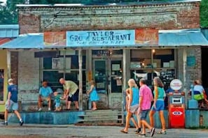A building with a sign that reads "Taylor Grocery Restaurant."