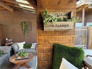 A rustic wooden wall with a vintage sign reading '1876 LOS ALAMOS' and a planter with greenery. - Heritage House ~ Living Art ~ Steps from Bell St (Los Alamos)