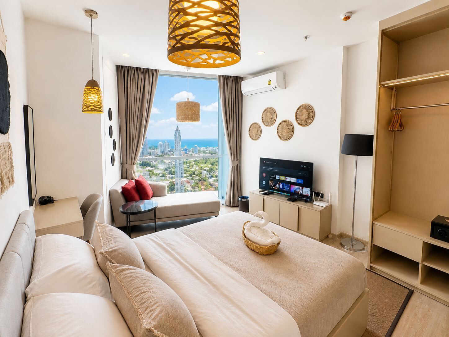 A modern hotel room with a large bed, a television, and a view of the cityscape.
