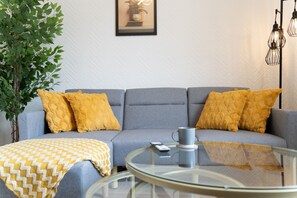 Relax in this stylish living room with a sofa, coffee table, and floor lamp.