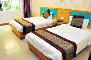 Two single beds with headboards, a nightstand, and a window with curtains. - Yidelong Hotel (Sanya)