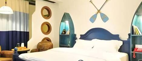 A bedroom with a bed, a nightstand, a chair, and a wall-mounted shelf.