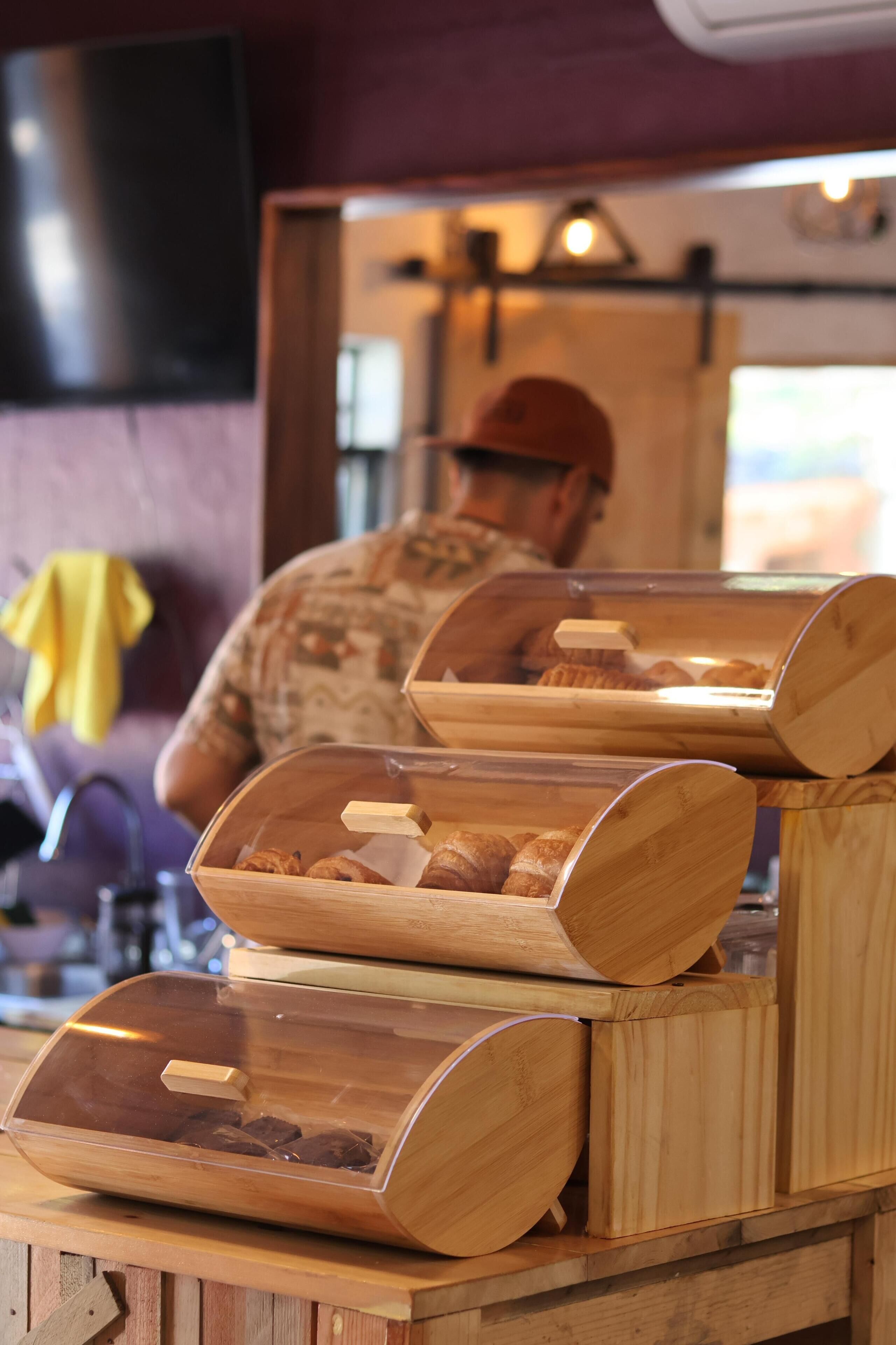 A bakery display with wooden containers holding pastries.