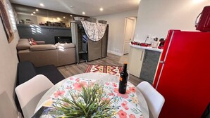 A compact living space with a dining area, kitchen, and seating area. - Private Bachelor Unit close to St. Clair College walking distance  (Windsor)