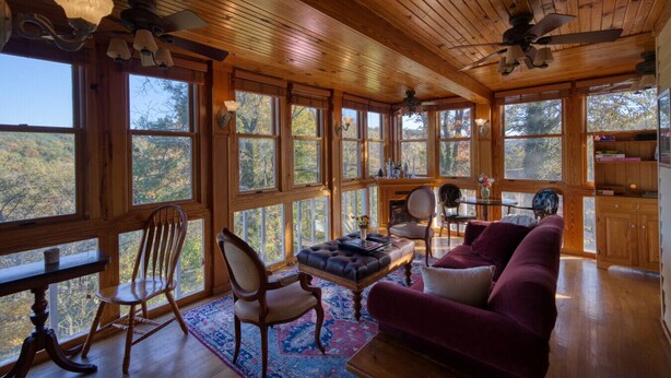 A spacious room with large windows, wooden ceiling, and a cozy seating area with a sofa and chairs. - Downtown Edgewood Terr Piedmont (Eureka Springs)
