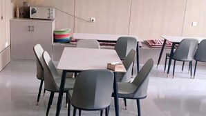A modern dining area with a rectangular table surrounded by six chairs. - Pandora Fashion Hotel (Yanji Yanbian University West Market Branch) (Yanji)