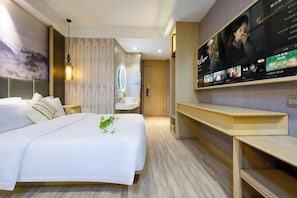 A modern hotel room with a large bed, a bedside table, a TV mounted on the wall, and a wooden floor. - Taihe Kaida Business Hotel (Taihe People's Hospital) (Taihe)