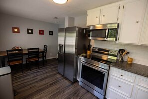 Fridge, microwave, oven, stovetop - Cottage ATX | 3BR • GFiber WiFi • Keep Austin Cozy (Austin)