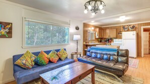A living room with a blue sofa, colorful pillows, a wooden coffee table, and a leather couch. - Rustic Cabin w/ Patio: 8 Mi to Kings Canyon Park (Miramonte)