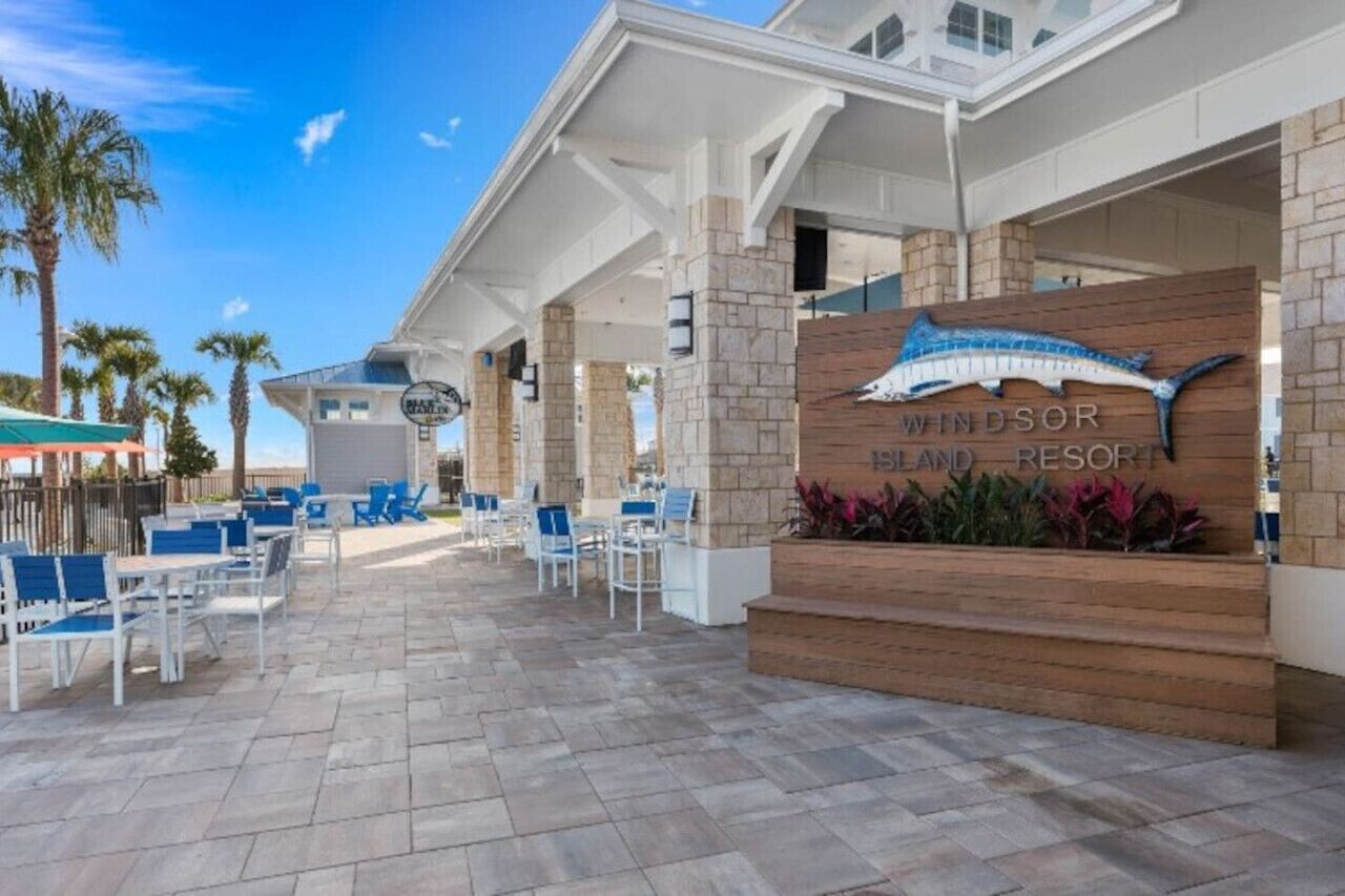 A resort's outdoor seating area with a sign for Windsor Island Resort.