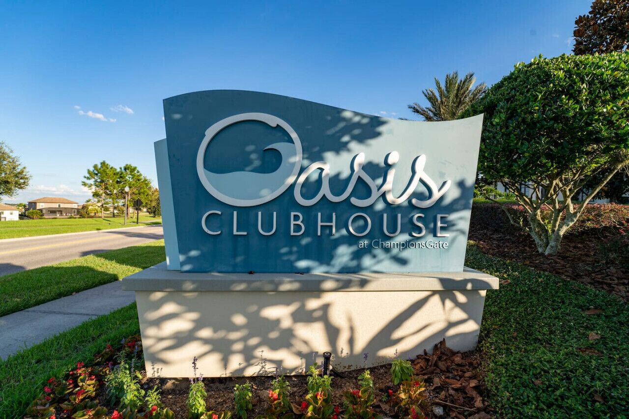A sign for Oasis Clubhouse at Champions Gate.
