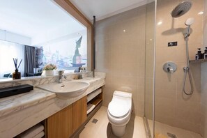 A modern bathroom with a marble countertop, a toilet, and a glass-enclosed shower. - Pudong Fute Hotel (Xiepu Road Subway Station) (Shanghai)