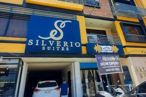 A hotel entrance with a sign for 'Silverio Suites' and a 'NOW OPEN' sign. - 153 Silverio Suites Paranaque City (ParaƱaque)