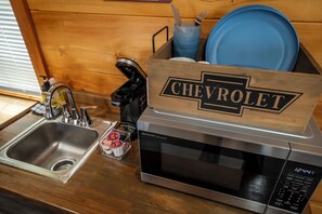 Fridge, microwave, coffee/tea maker, cookware/dishes/utensils
