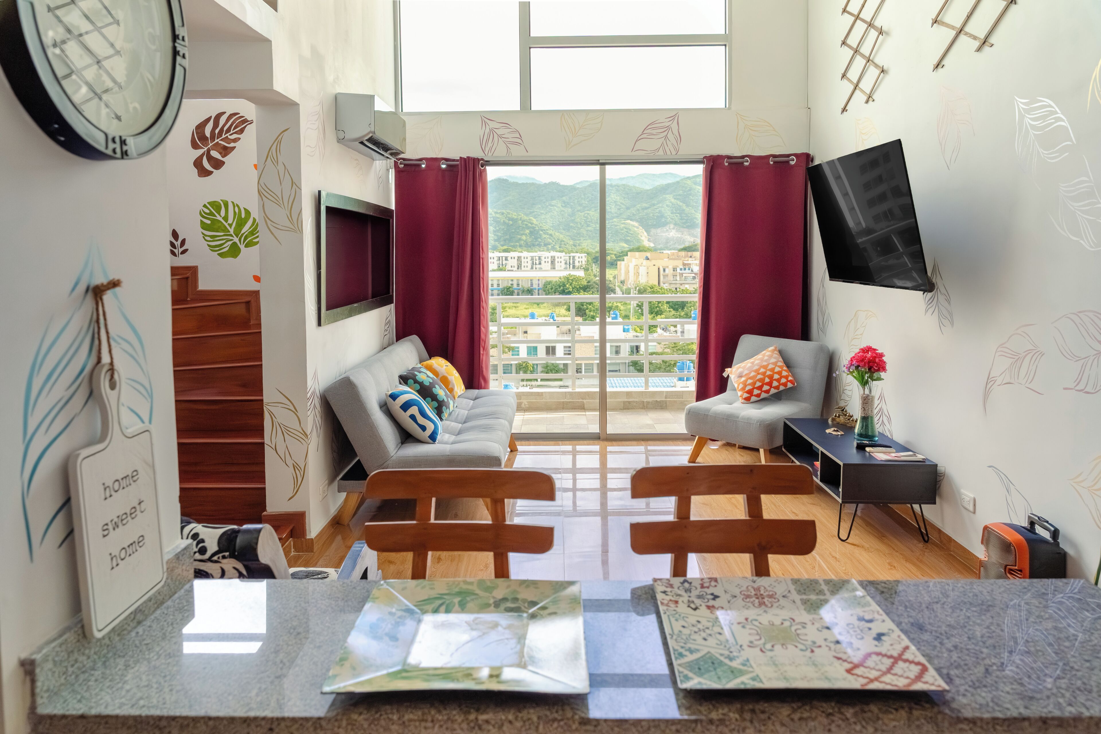Main living room with 55 inch HDTV, sleeper sofa, AC, balcony. Motorized shade.