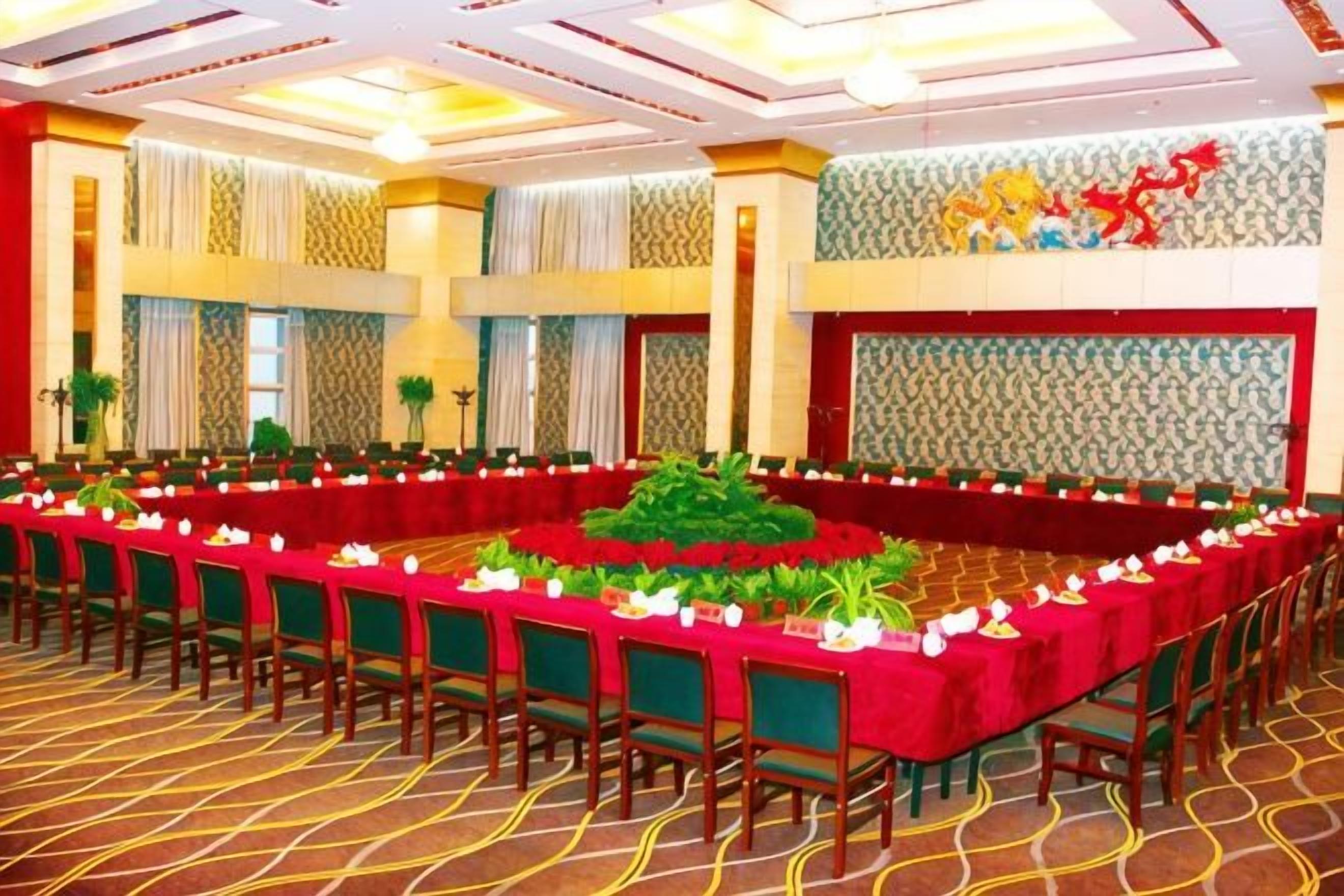 A banquet hall with long tables, chairs, and a decorative centerpiece.