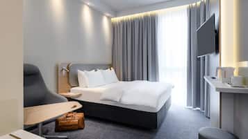 Hypo-allergenic bedding, desk, laptop workspace, blackout curtains