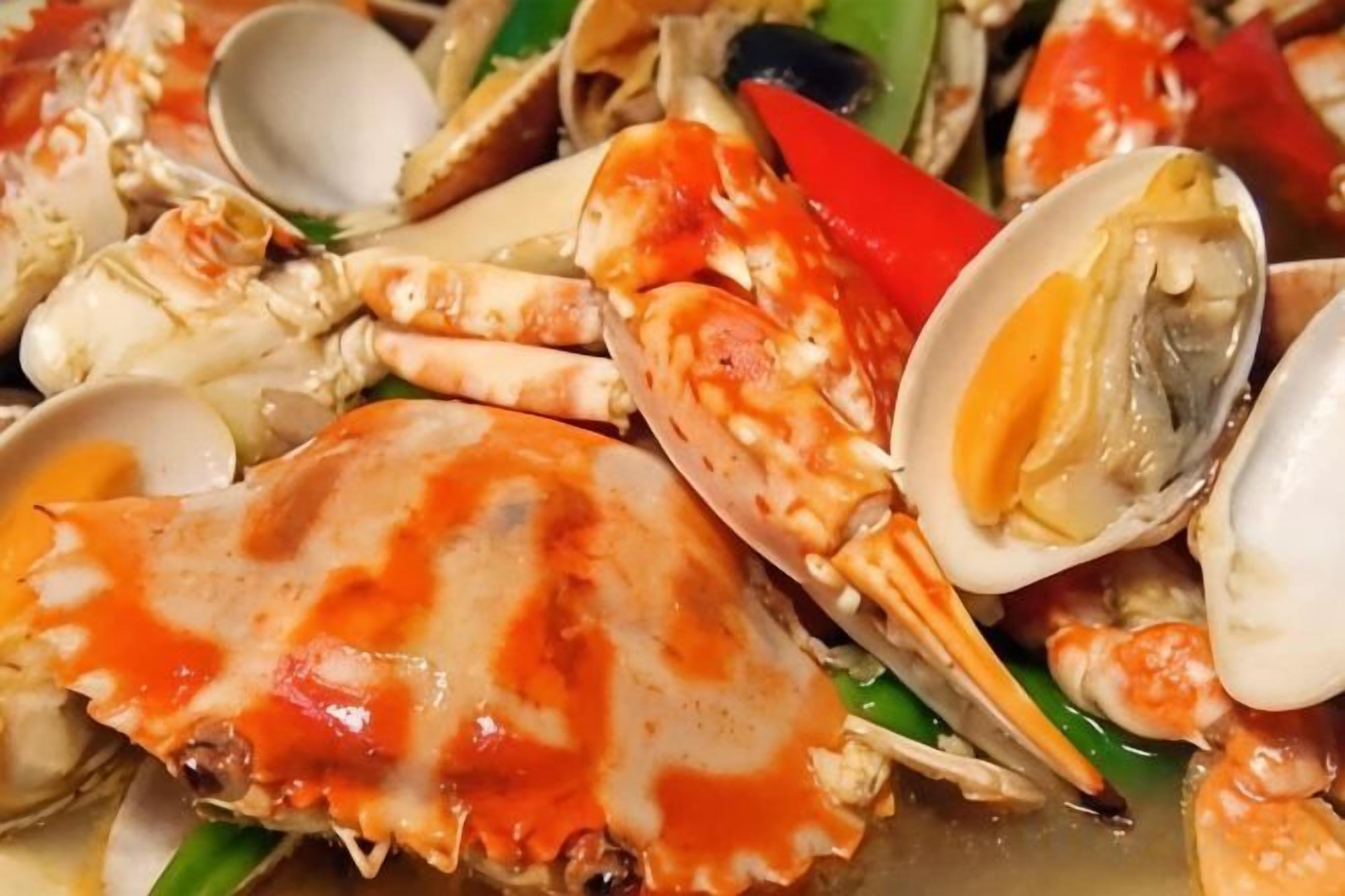 A close-up of a seafood dish with various shellfish.