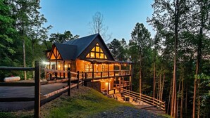 A cabin with a balcony, surrounded by trees. - Cabin·Indoor Pool·Sauna·Game Rm·Creek·15 Min to NP (Sevierville)