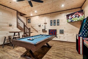 A pool table in a room with wooden walls and a ceiling fan. - Cabin· Pool·Hot Tub·Sauna·Creek·Sleeps 12 (Sevierville)