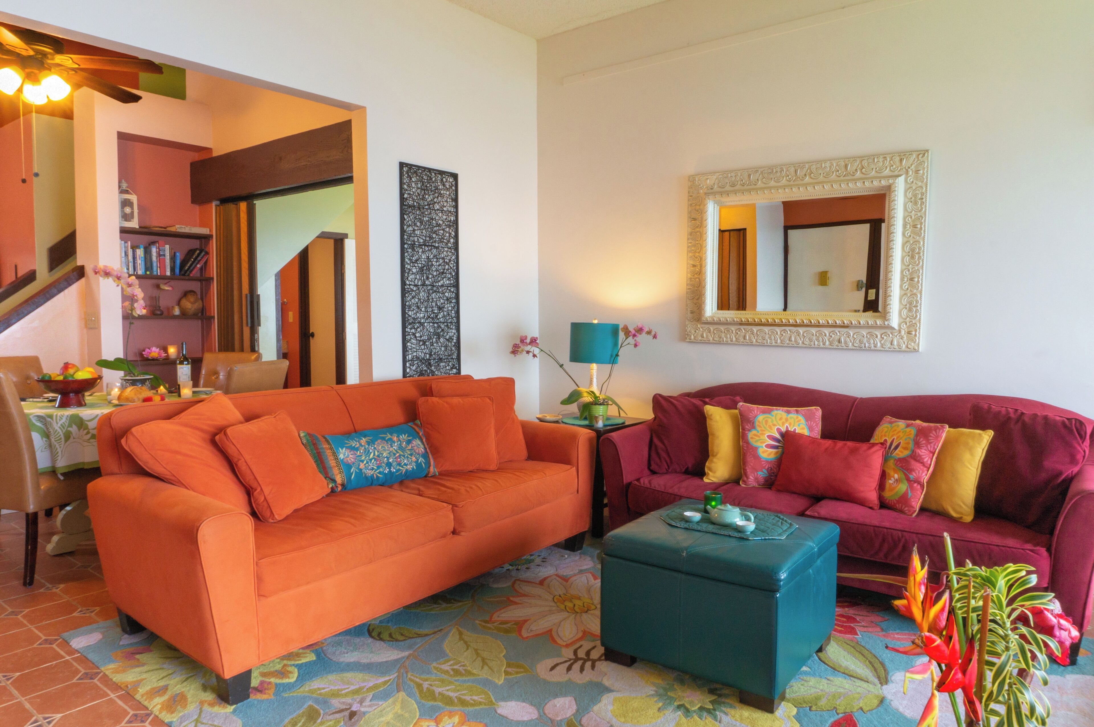 A living room with two sofas, a coffee table, and a bookshelf.