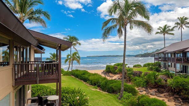 A beachfront property with a covered deck and a view of the ocean. - Hanalei Colony Resort H4 (Hanalei)