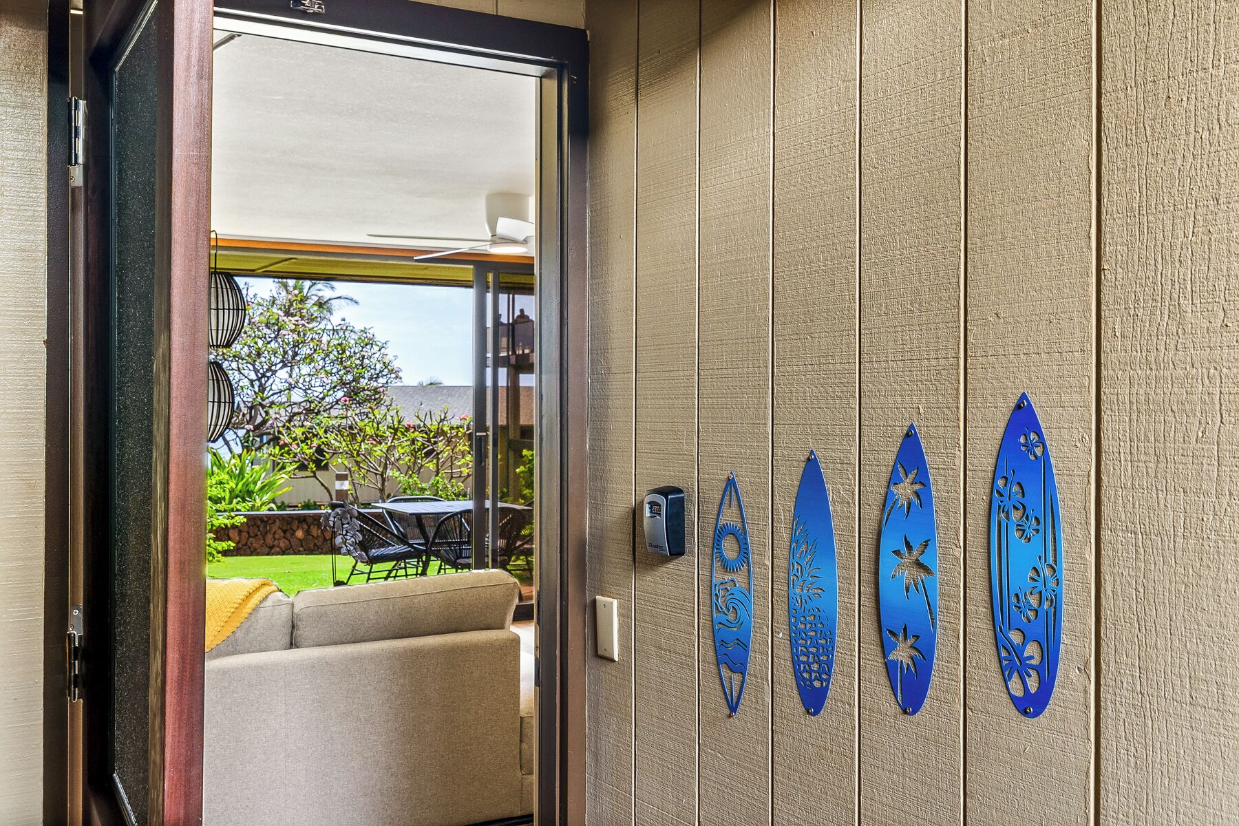 A hotel room entrance with a sliding door leading to a balcony.