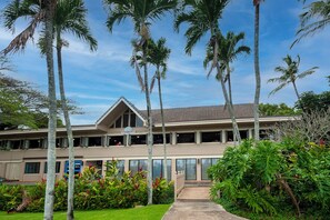 A two-story building with a flat roof and a sign reading "KAPPAKIL-JOES". - Kahala at Poipu Kai 123 (Koloa)