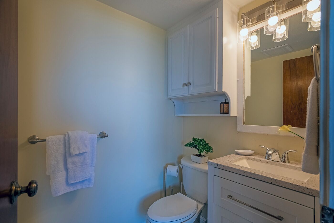 Une salle de bain avec des toilettes, un lavabo et un meuble de rangement.