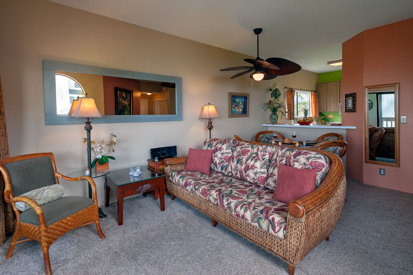 A living room with a sofa, armchairs, a coffee table, and a TV.