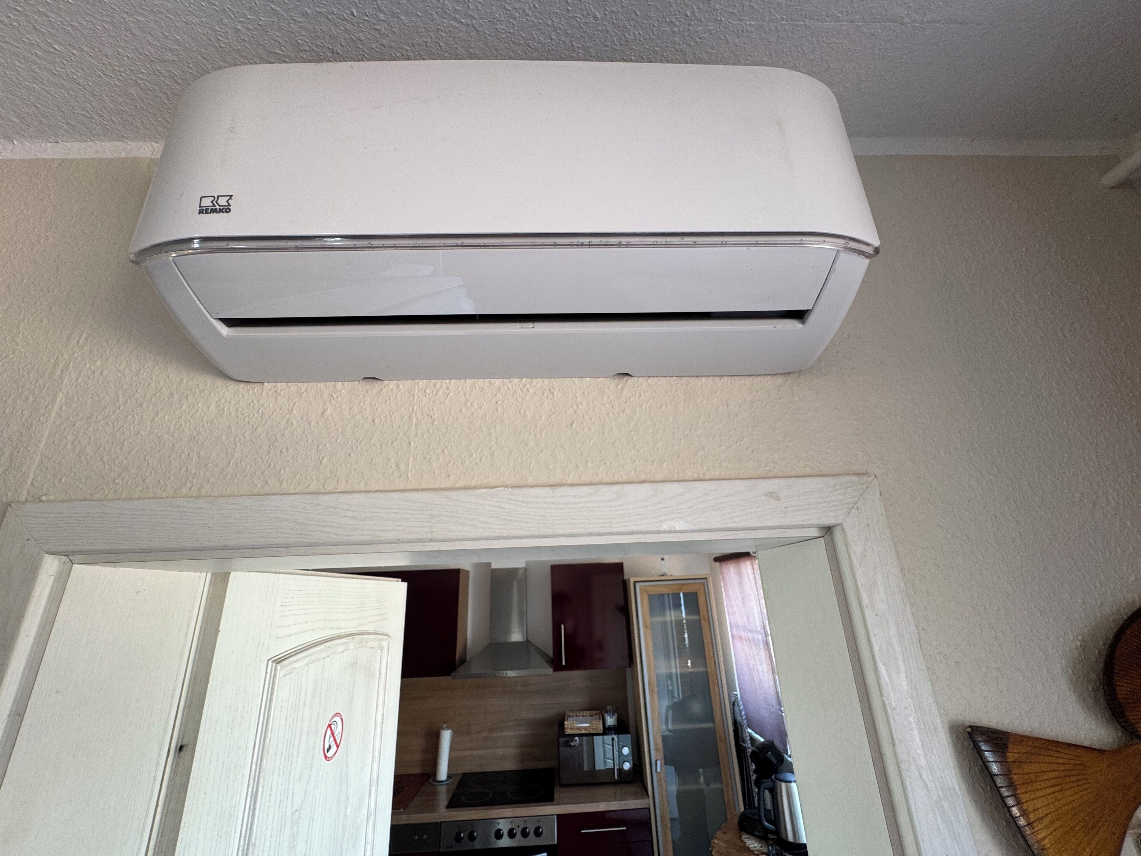 A white air conditioning unit mounted on a wall.