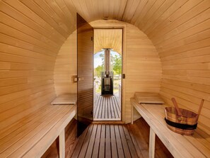 A sauna room with wooden walls and benches, a wooden floor, and a sauna unit visible through an open door. - Stunning private villa with hot tub, WIFI, TV, terrace, pets allowed and panoramic view (Lubian)