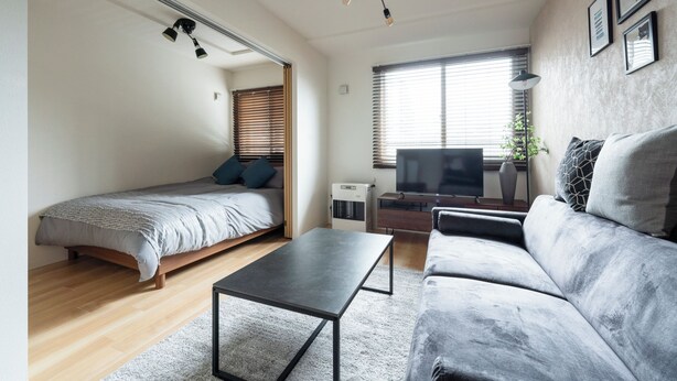 A modern living room with a bed, sofa, and a TV. - UNIFY 203 (Sapporo)