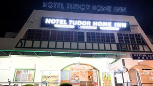 A hotel named "Hotel Tudor Home Inn" with a prominent sign displaying contact numbers. - Hotel Tudor Cameron Highland (Brinchang)