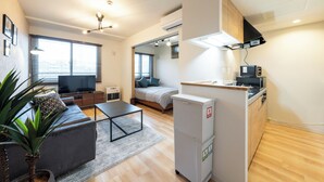 A modern apartment with a living room, kitchenette, and bedroom. - UNISON (Sapporo)