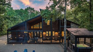A cabin with a deck, outdoor seating, and a fire pit. - Luxury Cabin*Hot Tub*Fire Pit*Game Room*Arcade (Broken Bow)