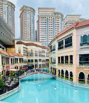 Un hôtel doté d’une piscine centrale, de plusieurs étages et présentant un mélange de styles architecturaux traditionnels et modernes.
