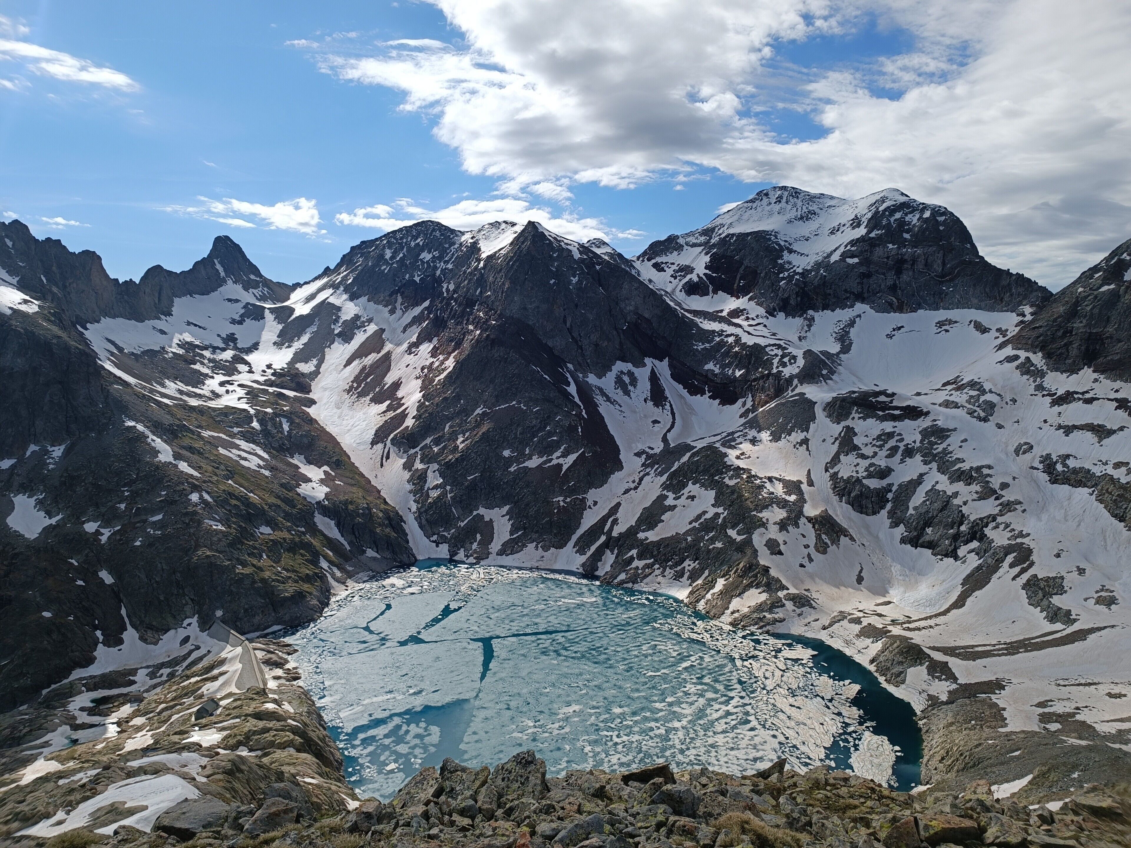 A mountainous landscape with a glacial lake and rugged terrain.
