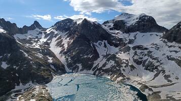 A mountainous landscape with a glacial lake and rugged terrain.