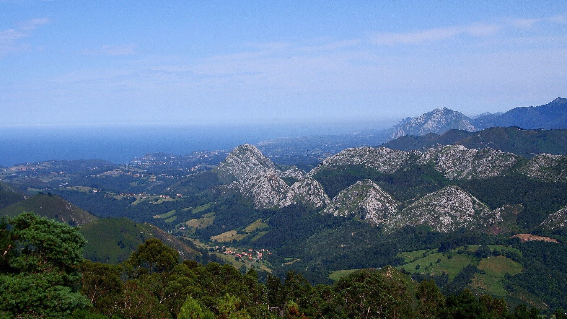 A mountainous landscape with rocky peaks and a valley.