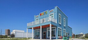 A two-story building with a blue exterior, a sign reading "Pete's Donuts," and a visible entrance.