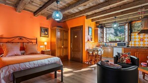 A bedroom with a bed, bedside table, and a wooden ceiling. - Casa Rural 'Nogueira' with Mountain Views, Private Terrace, and Wi-Fi (A Fonsagrada)