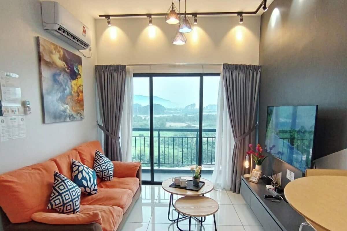 A modern living room with a sofa, coffee table, and a TV.