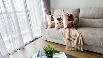 Executive Apartment | Living area | 32-inch flat-screen TV with digital channels