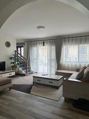 City Apartment | Living area | Flat-screen TV - Divine Furnished Apartments (Kampala)